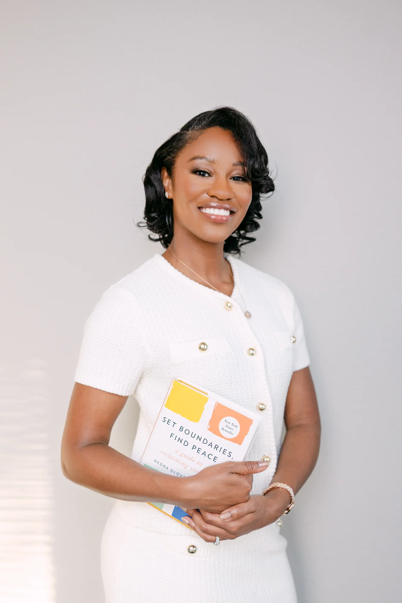 Wansley Harrison smiling and holding Set Boundaries, Find Peace