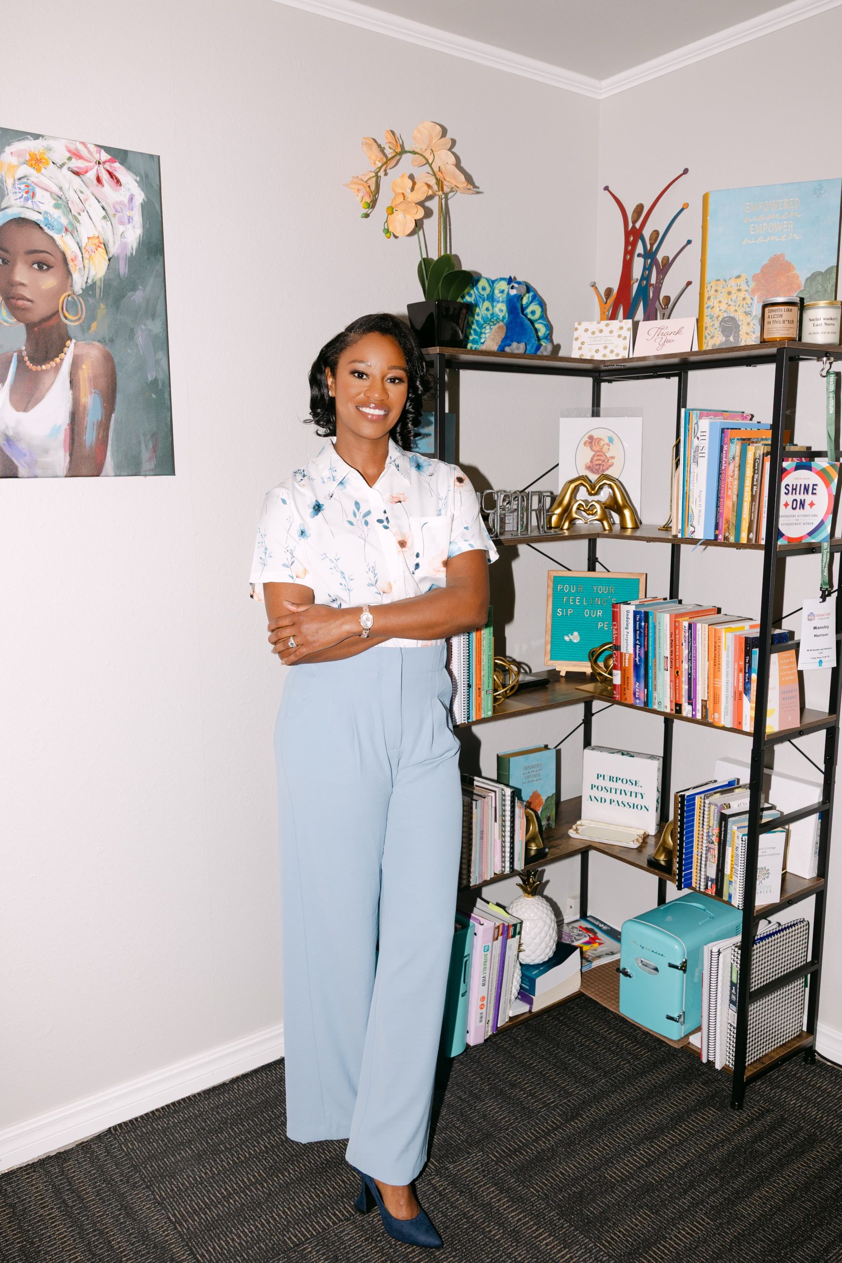 Wansley Harrison standing beside a bookshelf